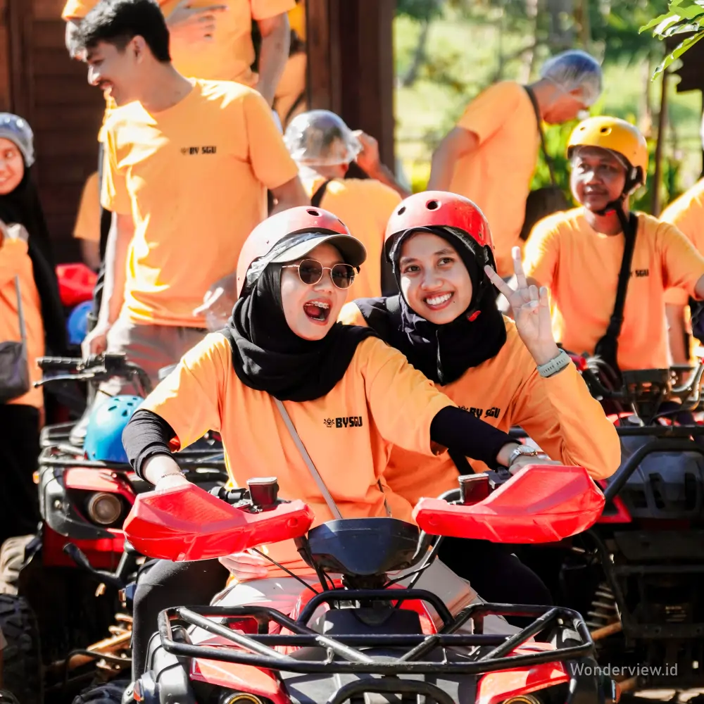 Dua wisatawan perempuan menikmati perjalanan ATV seru di Banyuwangi.